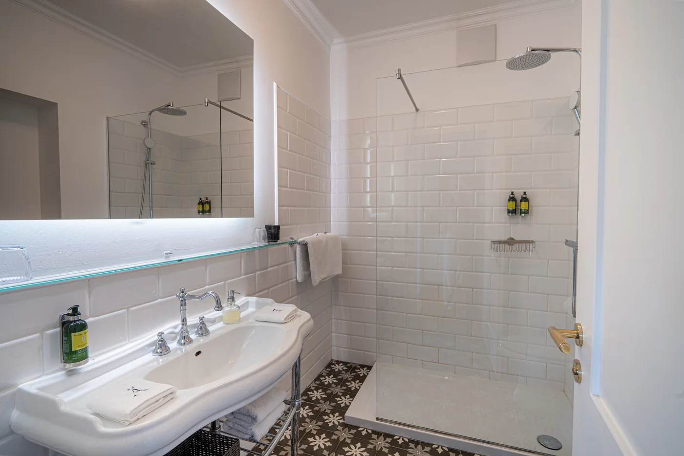 Deluxe Suite bathroom with a glass shower enclosure