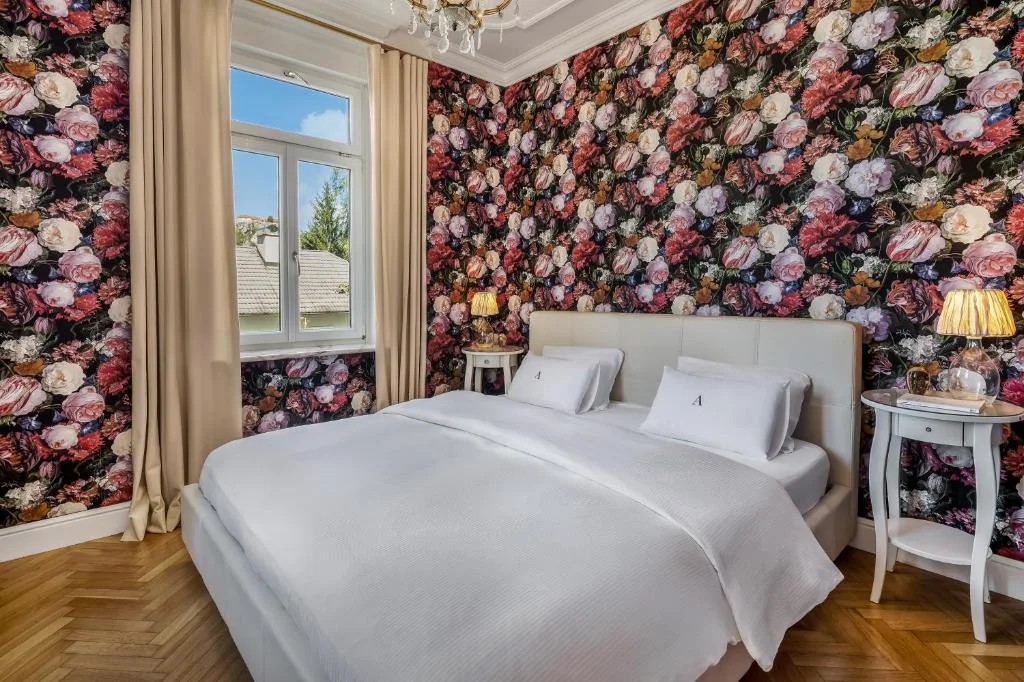 First bedroom with floral wallpaper in the Executive Suite
