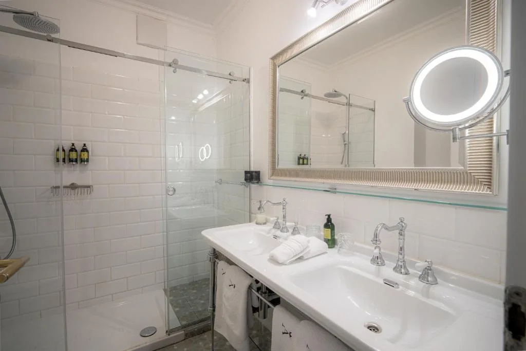 Executive Suite bathroom with a shower and twin basins