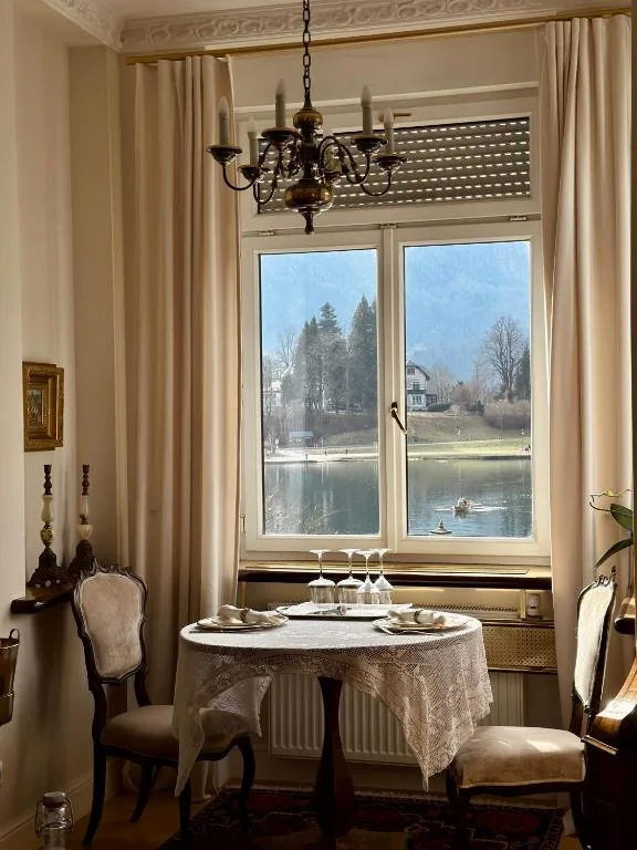 Dining table by a lake-facing window in the Prestige Suite
