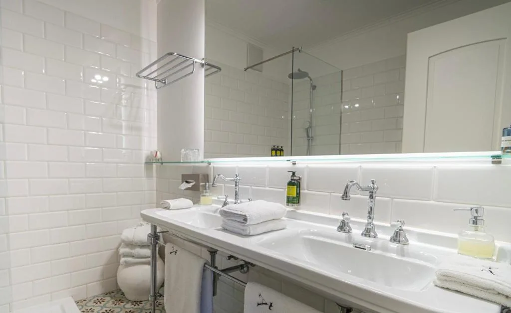 Superior Suite bathroom with twin basins and a shower