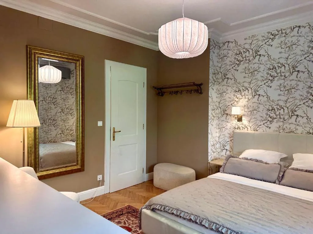 Double Room with a queen-size bed and botanical wallpaper