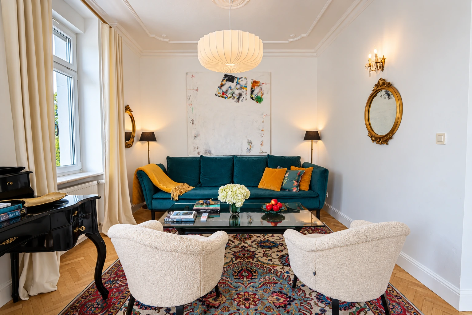 Deluxe Suite living room with a teal sofa and cream armchairs