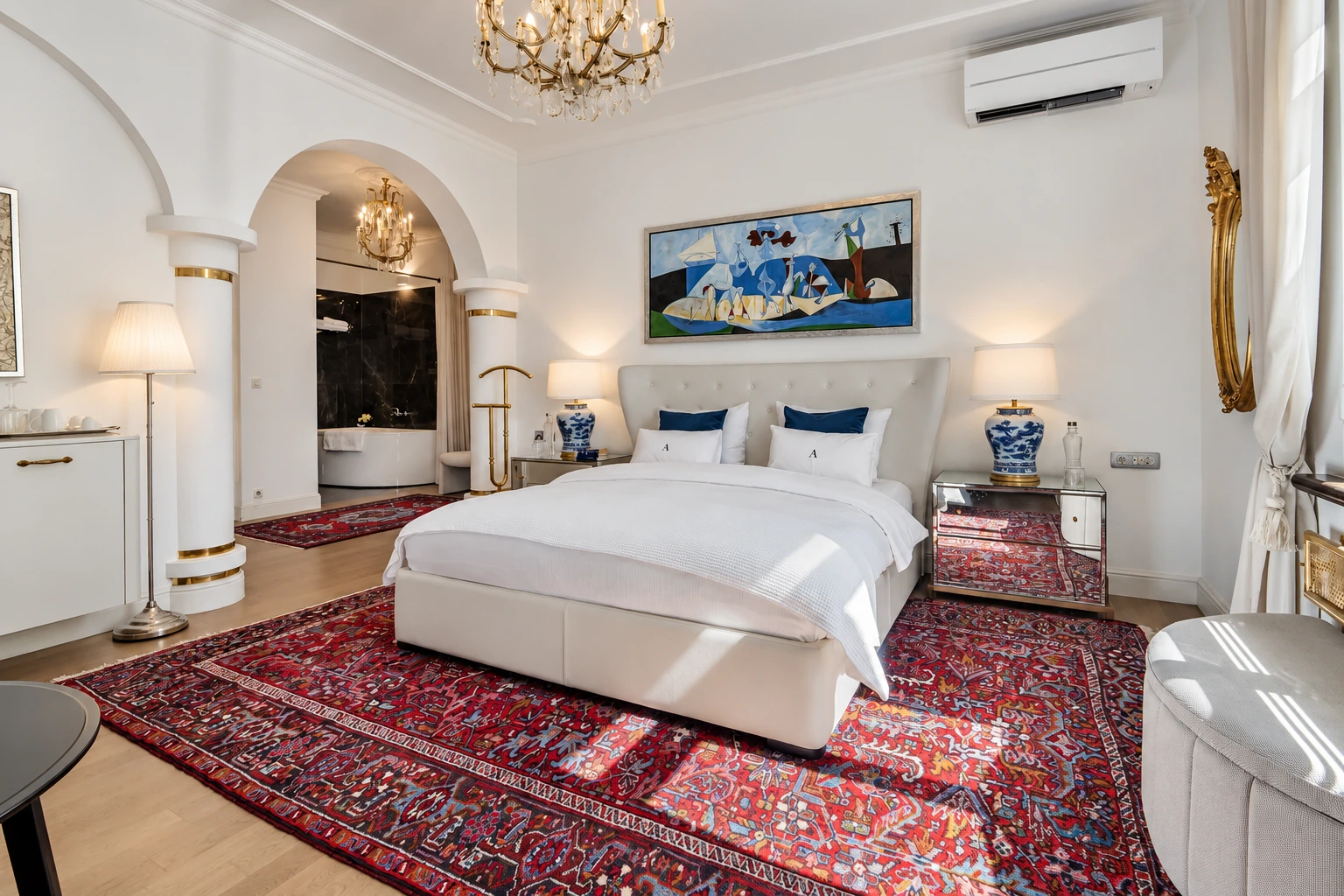 Luxury King Room with a white upholstered bed and an adjoining bathroom
